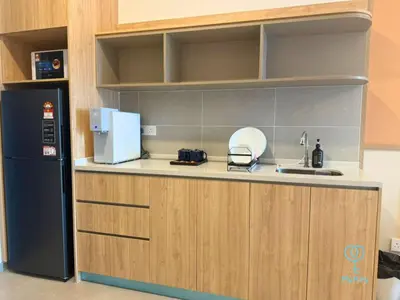 a kitchen with a black refrigerator and a sink at 22 Macalisterz by Mana Mana in George Town