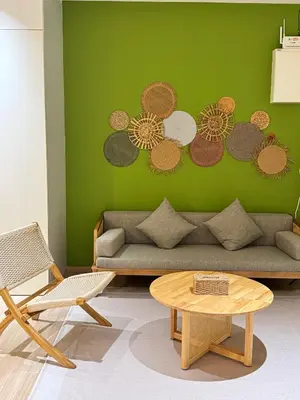 a living room with a couch and a green wall at Penang Stay 2-6px Convenient Free parking in George Town