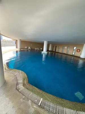 a large swimming pool with blue water in a building at Penang Stay 2-6px Convenient Free parking in George Town