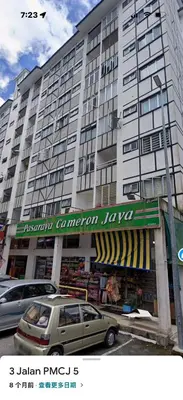 a large building with a car parked in front of it at Cameron Jaya Homestay 8pax in Tanah Rata