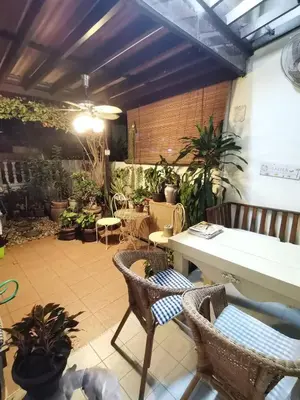 a patio with a table and chairs and plants at Cozy Home near Airport, & Bayan Lepas Industrial in Bayan Lepas