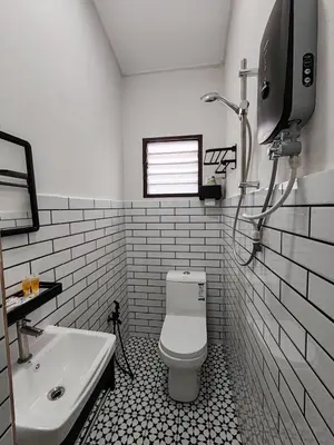 a bathroom with a white toilet and a sink at Tambun - Near LWOT, PLUS Highway Access ,Sunway & Pantai Hosp in Tambun