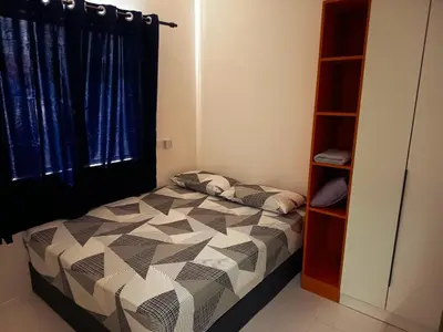 a bedroom with a bed and a book shelf at IFS Soho 3 Basic Home in Seri Iskandar