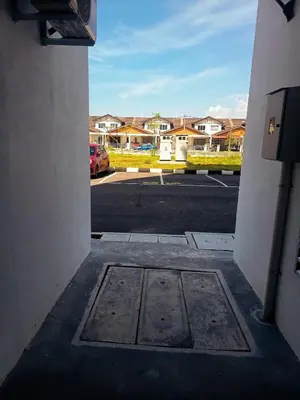 a view of a parking lot with a grate in the ground at IFS Soho 3 Basic Home in Seri Iskandar