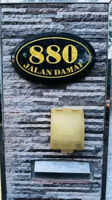 a sign on the side of a wooden building at Homestay, Lunas Kulim near BKE highway with 3 spacious rooms and fully furnished in Lunas