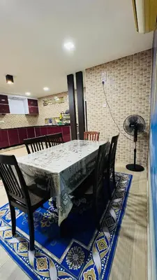a dining room table with chairs and a large table with at Homestay, Lunas Kulim near BKE highway with 3 spacious rooms and fully furnished in Lunas