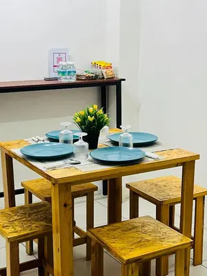 a wooden table with blue plates on top of it at Izzu Homestay Sungkai in Sungkai