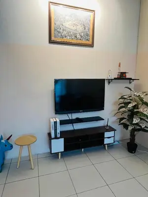 a living room with a flat screen tv on a wall at Izzu Homestay Sungkai in Sungkai