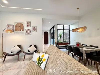 a living room with a couch and a dining room at BBC De Garden Homestay in Ipoh