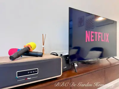 a television with a remote control on top of a dresser at BBC De Garden Homestay in Ipoh
