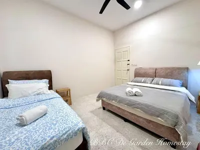 a bedroom with two beds with towels on them at BBC De Garden Homestay in Ipoh