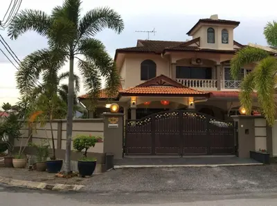 a house with a gate and a palm tree at Garden vibe STAYcation Hillside in Ipoh