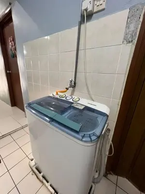a toilet with its lid up in a bathroom at Adila Homestay in Seri Iskandar
