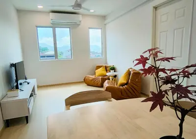 a living room with a table and a couch at K Room Homestay at Taiping in Taiping