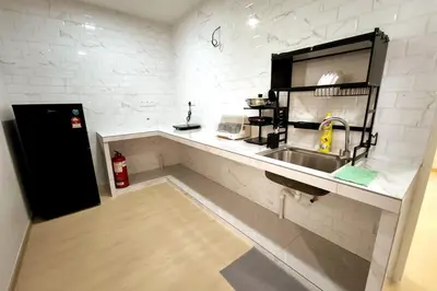 a kitchen with a sink and a counter at K Room Homestay at Taiping in Taiping