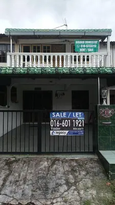 a sign on a fence in front of a house at Aishah homestay in Ipoh