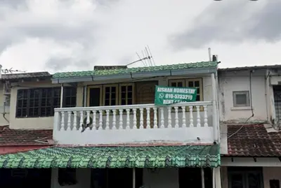 a building with a sign on top of it at Aishah homestay in Ipoh