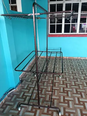 a metal bed in a room with a blue wall at Homestay Sayang in Ipoh