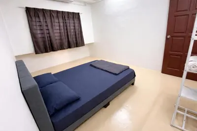 a small bedroom with a blue bed in a room at 525A Homestay Malim Nawar in Malim Nawar
