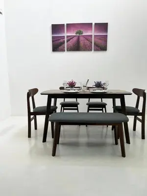 a wooden table with chairs and a painting on a wall at twelve homestay ipoh in Ipoh