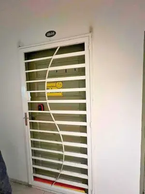 a garage door with a sign on it in a room at THE QUINTET BY D Atas Bukit Antarium in Tanah Rata