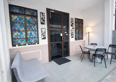 a room with a table and chairs and stained glass windows at MediSehat KamarKu - Just 20 meters to Gleneagles Hospital Penang in George Town