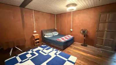a living room with a couch and a rug at Laman Warisan Opah Homestay in Manong
