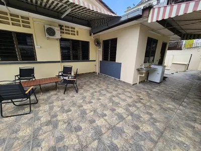 a patio with chairs and a bench and a building at House of Lights in Batu Gajah