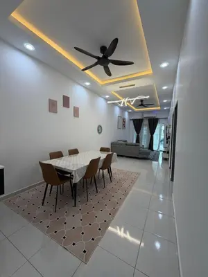 a dining room with a table and a ceiling fan at Homestay Yunaz in Kampong Banggol Pasir