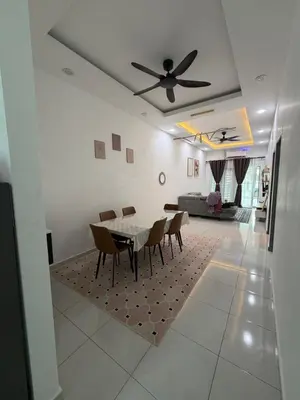 a dining room with a table and a ceiling fan at Homestay Yunaz in Kampong Banggol Pasir