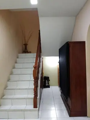 a stairway with white stairs and a stair case at NORDIAZZ Home in Ipoh