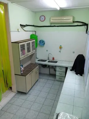 a kitchen with a counter and a sink and a clock at NORDIAZZ Home in Ipoh