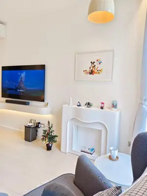 a living room with a tv and a fireplace at 22 Macalisterz - King Suite - 65