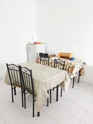 a dining room table with chairs and a table cloth at Homestay Taman Segar 23 for musleem in TanjongMalim