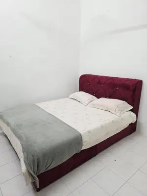 a bed with a red headboard in a room at Homestay Taman Segar 23 for musleem in TanjongMalim