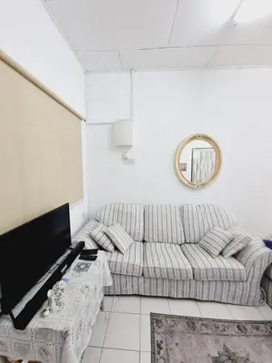 a living room with a couch and a tv at Homestay Taman Segar for musleem in TanjongMalim