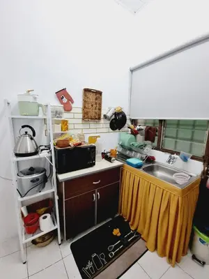 a small kitchen with a sink and a microwave at Homestay Taman Segar for musleem in TanjongMalim