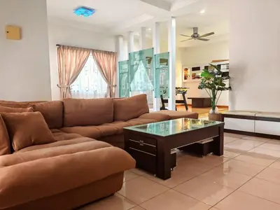a living room with a couch and a coffee table at 10paxx HotSprings Recovery Stay in Ipoh