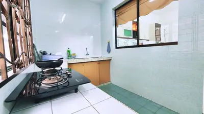 a kitchen with a stove and a window in it at 10paxx HotSprings Recovery Stay in Ipoh