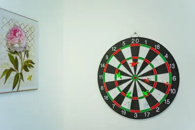 a dart board on a wall next to a picture at Spacious 4BR Corner with Pool Table in Ipoh