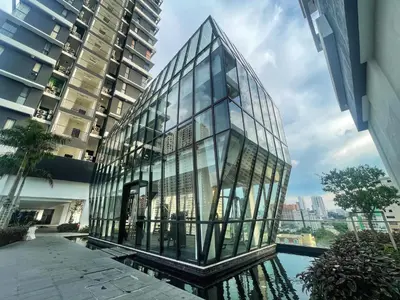 a glass building with a pool in front of a building at Le Cozy Cabin - 2B2R SeaCity View Infinity Pool in George Town