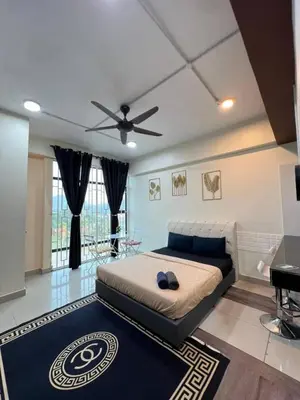 a bedroom with a bed and a ceiling fan at GR studio APARTMENT 3 - kompleks MUTIARA gua MUSANG in Gua Musang