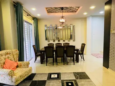 a living room with a dining room table and chairs at The Grand Crystal Retreat 4-Bedroom Luxury Villa in Taiping