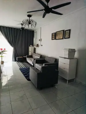 a living room with a couch and a ceiling fan at AR Homestay SP TRJ in Sungai Petani