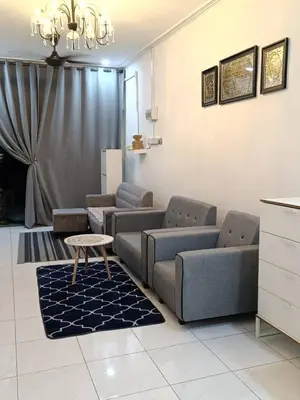 a living room with couches and a table in it at AR Homestay SP TRJ in Sungai Petani
