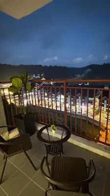 a balcony with chairs and a table and a view at DADDY HOMES 4 EMERALD AVENUE CENTRUM Brinchang View in Brinchang