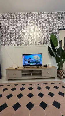 a flat screen tv sitting on top of a entertainment center at DADDY HOMES 4 EMERALD AVENUE CENTRUM Brinchang View in Brinchang