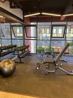 a room with a gym with a ball and a machine at Modern Two Bedroom Ipoh City Apartment with Pool, Gym and Free Parking in Ipoh