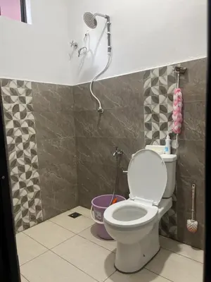 a bathroom with a toilet and a shower at Homestay Anjang in Tapah
