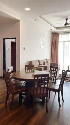a living room with a table and chairs and a couch at Bayt Rizq Homestay 3R2B in Brinchang